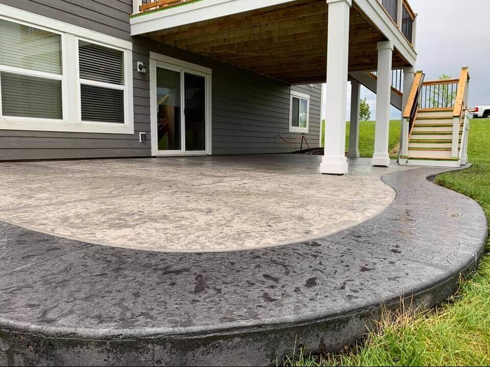 A stamped back patio with a deck