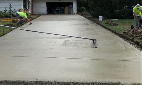 Finishing a concrete driveway with hand tools